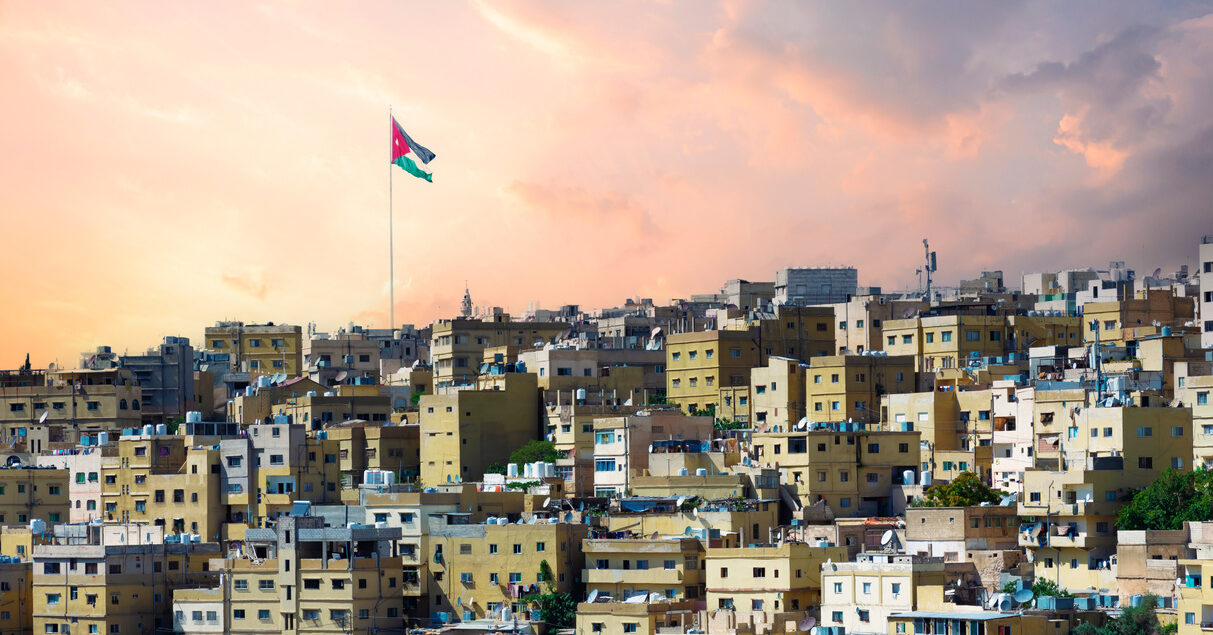 Old houses in Amman city with Jordan flag in the back of it. JABAL AMMAN